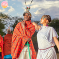 Two people in traditional maasai attire with a scenic background. with love from kenya, story mailed letters delivered to your mailbox each month